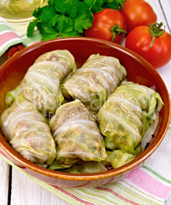 Cabbage stuffed with sauerkraut in ceramic pan on napkin