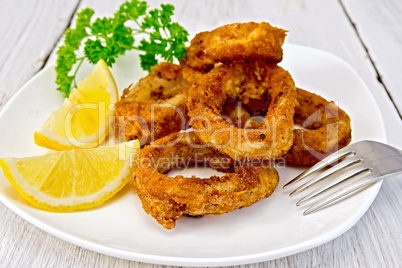 Calamari fried with lemon on plate