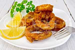 Calamari fried with lemon on plate