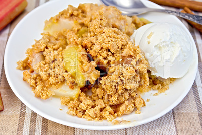 Crumble with rhubarb in dish on linen tablecloth