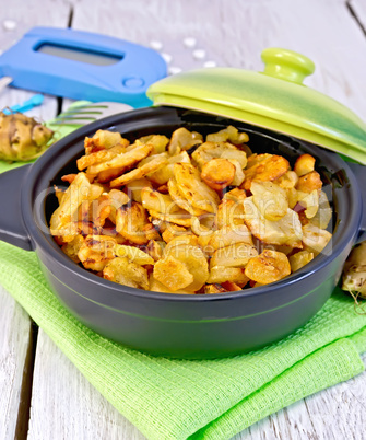 Jerusalem artichokes roasted in pan with meter on light board