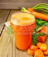 Juice carrot with leaf on board