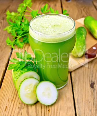 Juice cucumber with knife on board