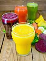 Juice vegetable in four glasses on board