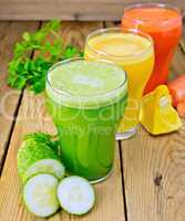 Juice vegetable in three glasses on wooden board