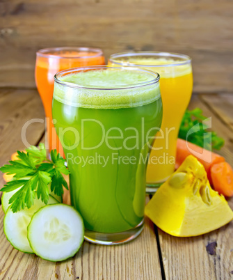 Juice vegetable in three glasses with vegetables on board