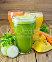 Juice vegetable in three glasses with vegetables on board