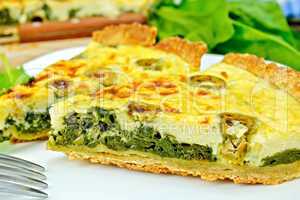 Pie with spinach and olives on plate