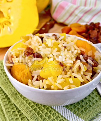 Pilaf fruit with pumpkin in bowl on board