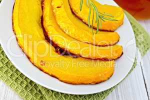 Pumpkin baked with honey in bowl on napkin