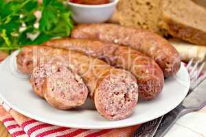 Sausages pork fried in plate on board with parsley