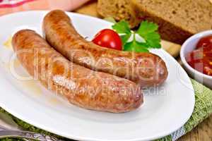 Sausages pork fried in plate on board