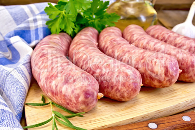 Sausages pork with rosemary on board