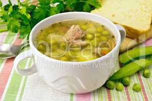 Soup from green peas with meat on napkin