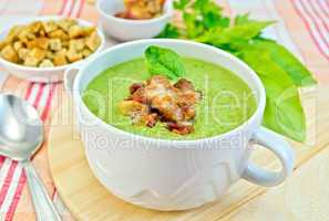 Soup puree with bacon and croutons on fabric