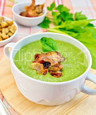 Soup puree with bacon and croutons on tablecloth