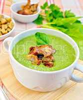 Soup puree with bacon and croutons on tablecloth
