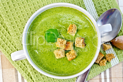 Soup puree with crackers and spoon on napkin