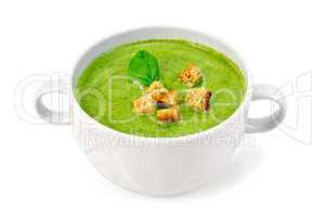 Soup puree with croutons and spinach in bowl