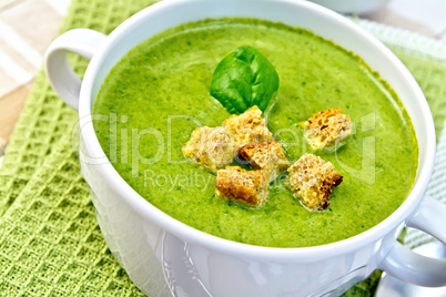 Soup puree with croutons and spinach on napkin