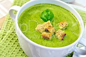 Soup puree with croutons and spinach on napkin