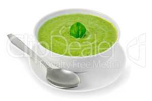 Soup puree with spinach in bowl and spoon