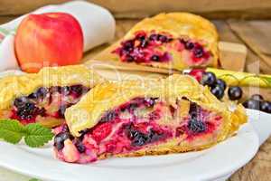 Strudel with black currants and apples on board
