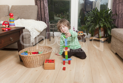 boy playing with building blocks