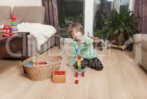 boy playing with building blocks