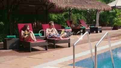 1of27 Young people relaxing in hotel swimming pool, gym, bar