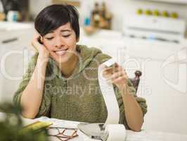 Multi-ethnic Young Woman Smiling Over Financial Calculations