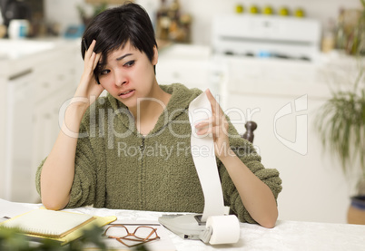 Multi-ethnic Young Woman Agonizing Over Financial Calculations