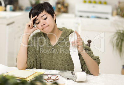 Multi-ethnic Young Woman Agonizing Over Financial Calculations