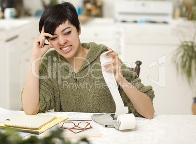 Multi-ethnic Young Woman Agonizing Over Financial Calculations