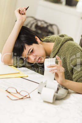 Multi-ethnic Young Woman Agonizing Over Financial Calculations