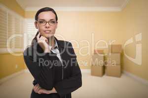 Mixed Race Woman in Empty Room with Boxes