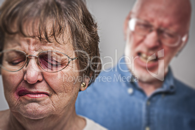 Battered and Scared Woman with Ominous Man Behind