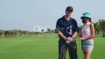 6of30 Portrait of happy couple playing in golf club, sport