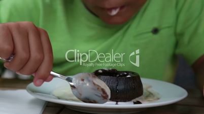 Child eating chocolate souffle