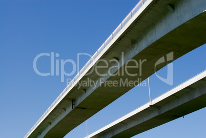 Pair of highway bridges on blue sky