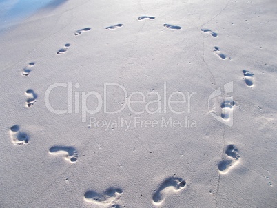 Circle of footprints in beach sand