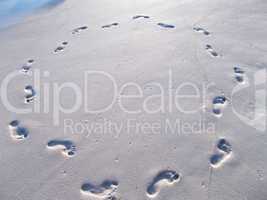 Circle of footprints in beach sand