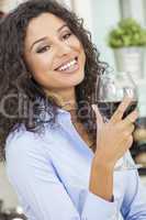 Hispanic Woman Smiling Drinking Red Wine