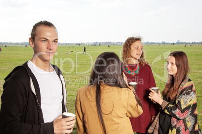 Group of young people having a picnic in the park