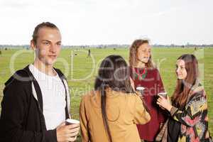 Group of young people having a picnic in the park