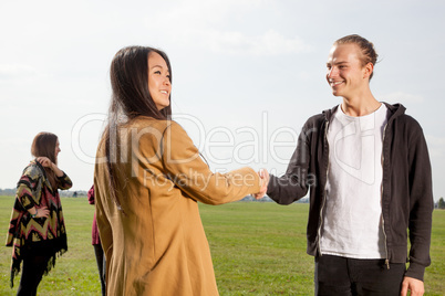 Man and woman greeting each other in the park