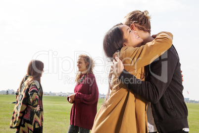 Man and woman greeting each other in the park