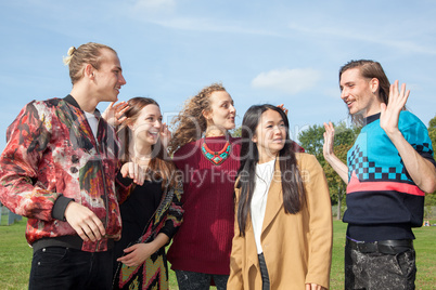 Waving group of young people