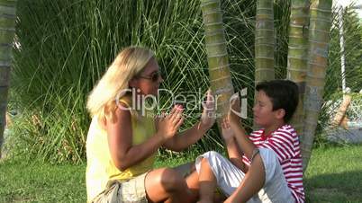 Mother and son relaxing time in park