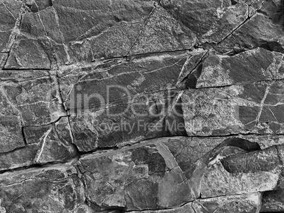 black and white stone rock with cracks in the background